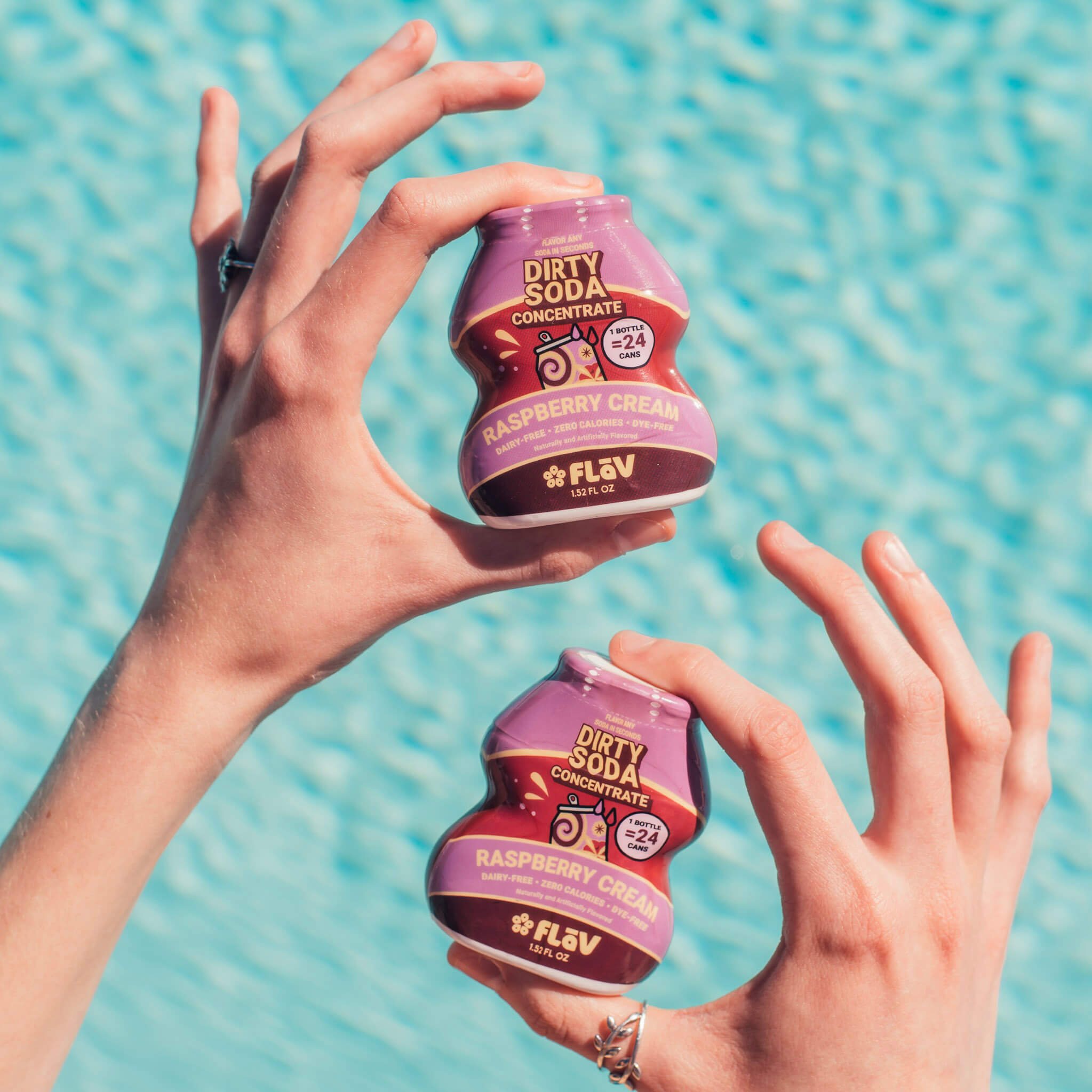 Raspberry Cream Flav bottles held poolside