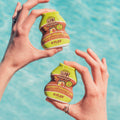 Coconut Cream and Lime Flav bottles held poolside