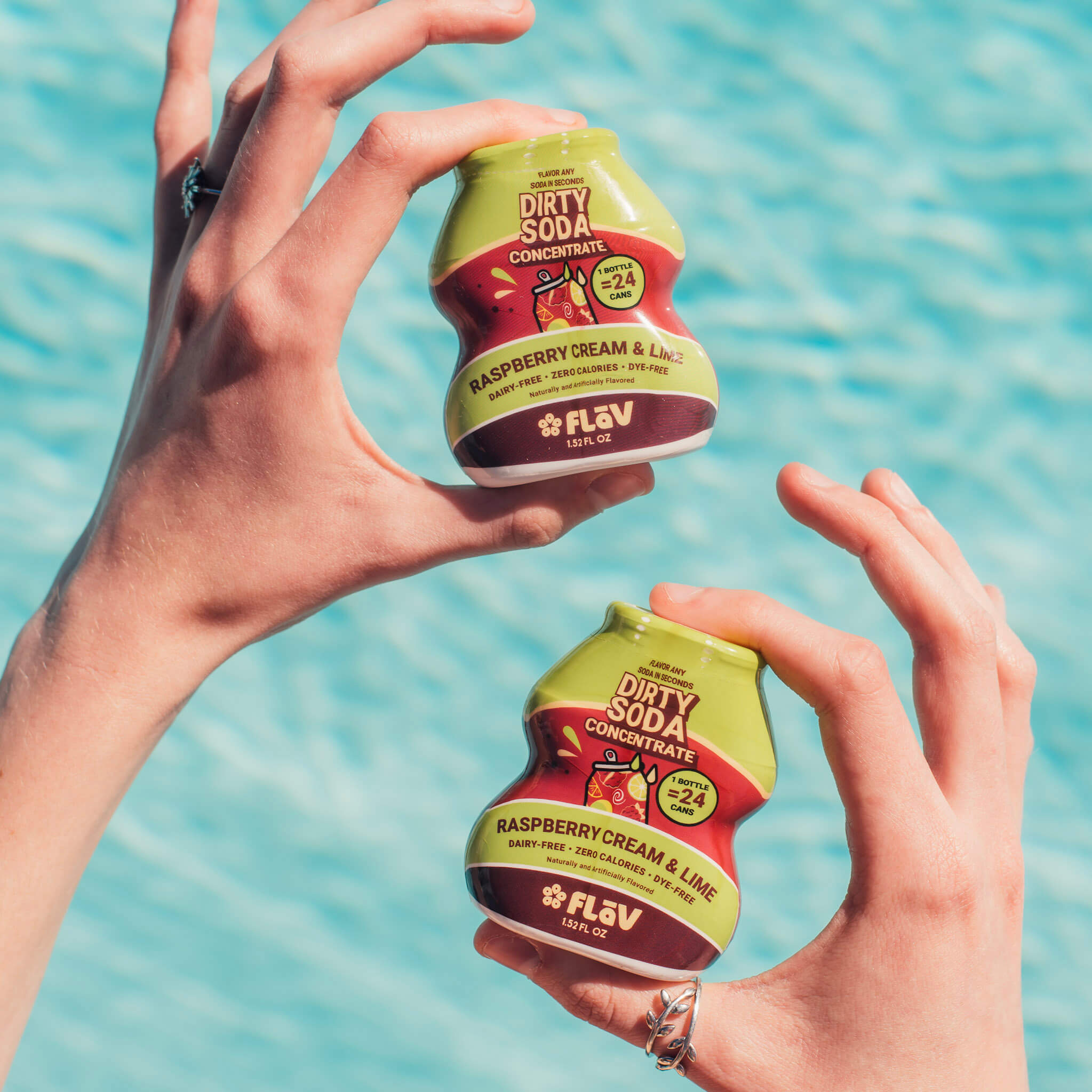 Raspberry Cream and Lime Flav bottles held poolside