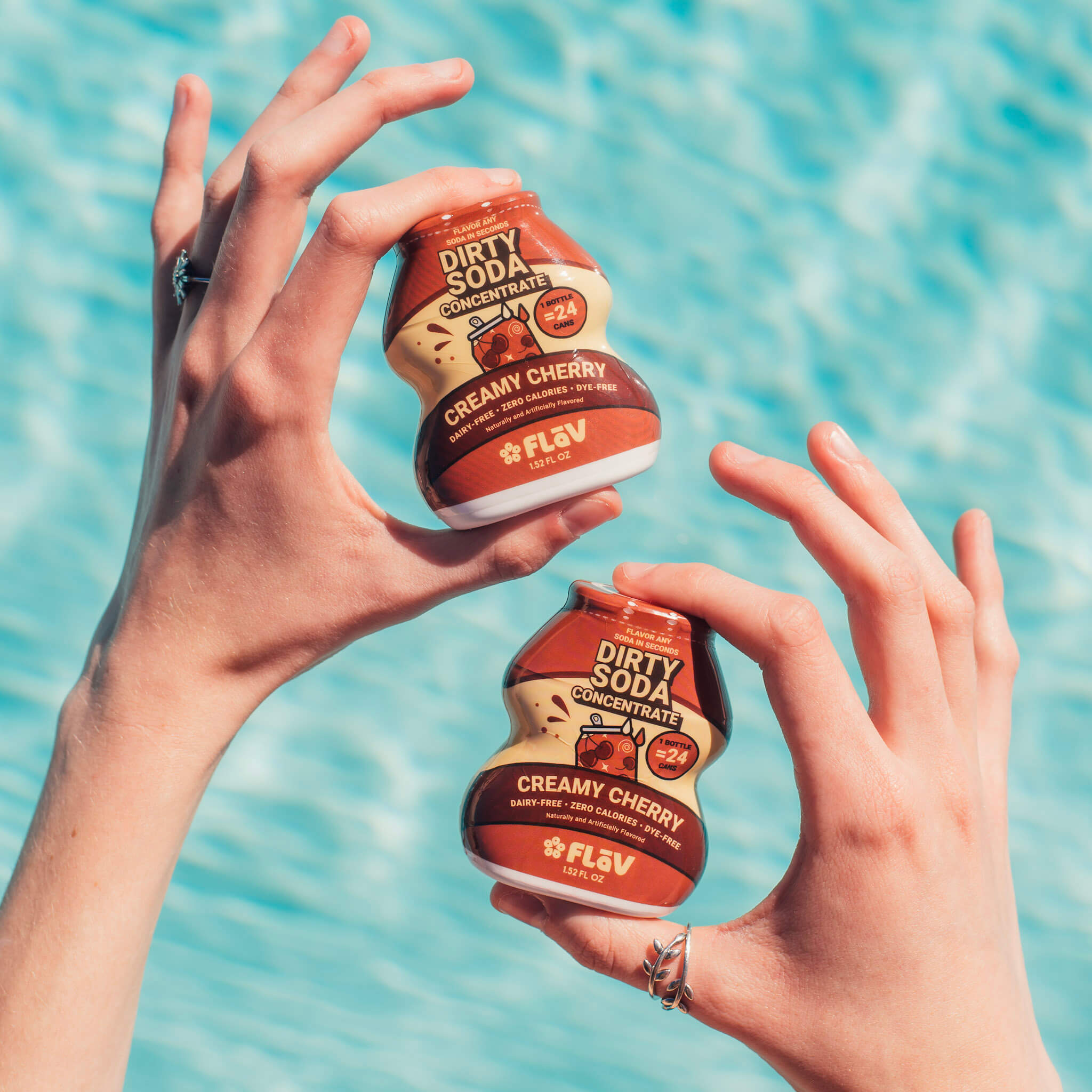 Creamy Cherry Flav bottles held poolside