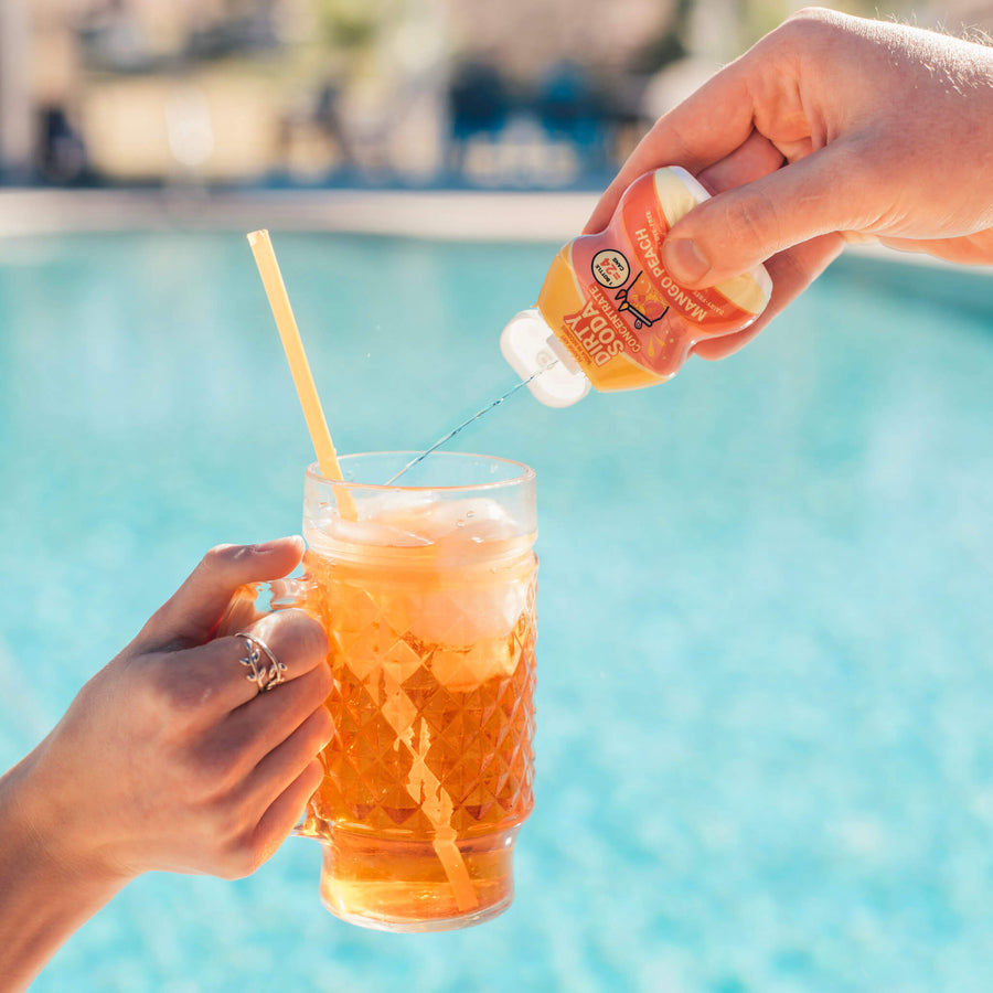 Flav concentrate being squeezed into a dirty soda